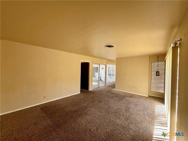 unfurnished room with baseboards, visible vents, and carpet floors