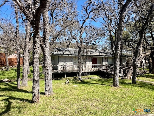 view of front facade with a yard and a deck