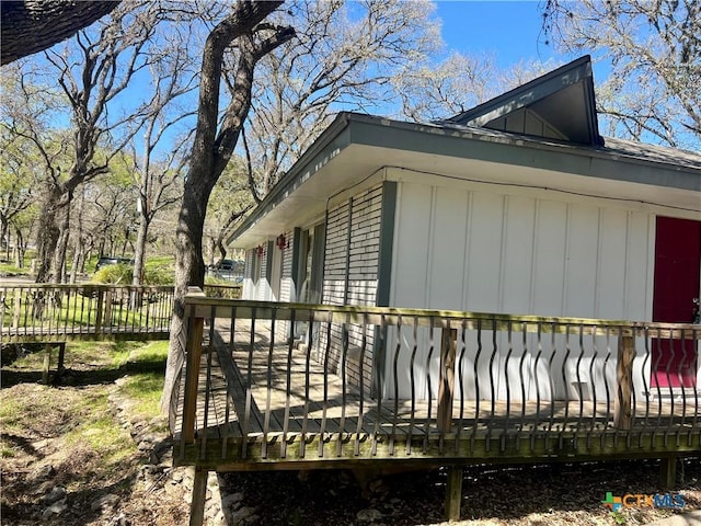 view of property exterior with a wooden deck and fence