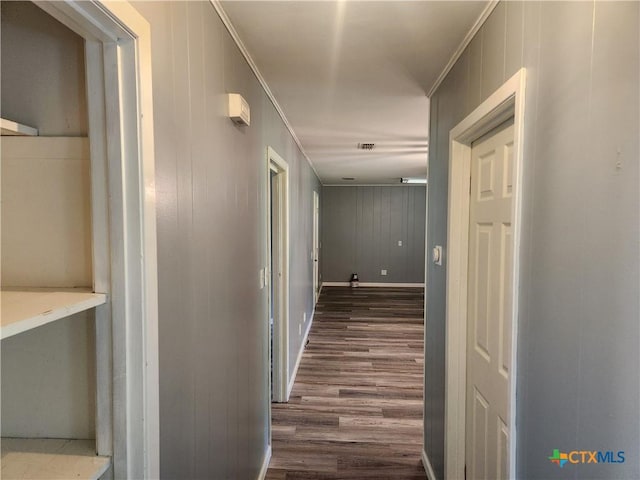 325 Montgomery St, Yoakum, TX 77995 - corridor featuring dark wood finished floors, ornamental molding, and wood walls