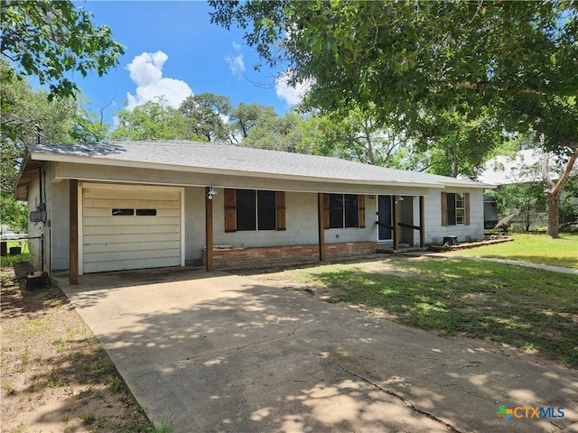 325 Montgomery St, Yoakum, TX 77995 - ranch-style house featuring an attached garage, concrete driveway, a front yard, and a shingled roof