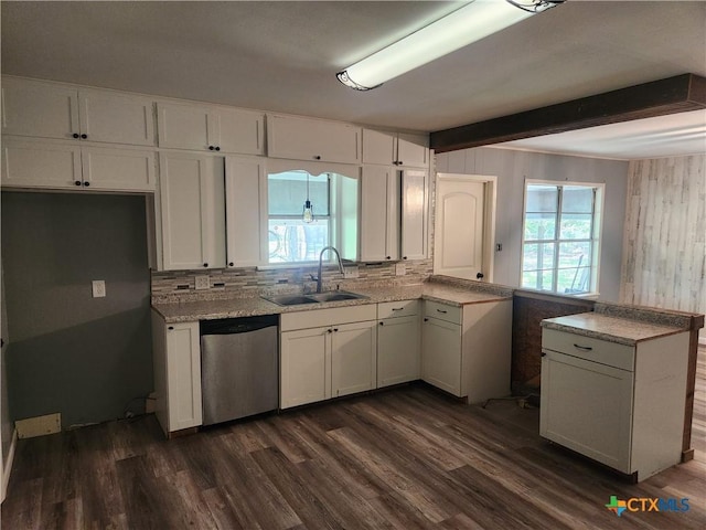 325 Montgomery St, Yoakum, TX 77995 - kitchen featuring dishwasher, a peninsula, white cabinetry, plenty of natural light, and beam ceiling