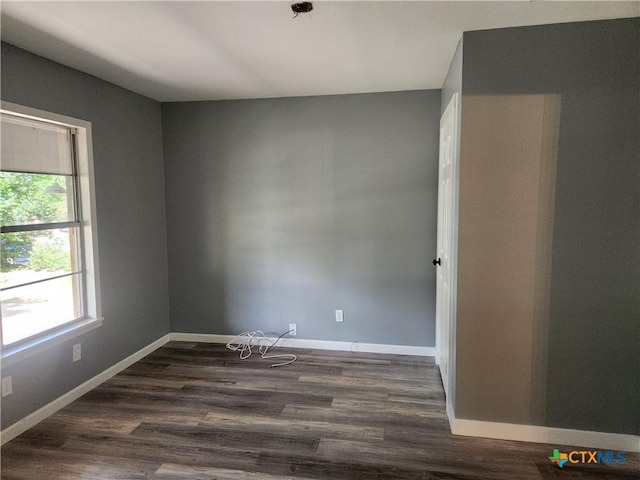 325 Montgomery St, Yoakum, TX 77995 - spare room with dark wood-style flooring and baseboards
