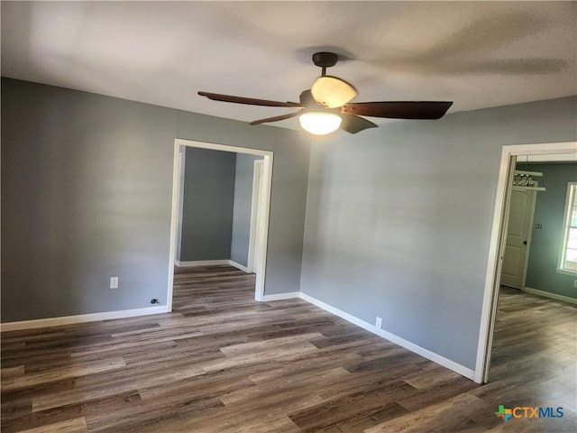 325 Montgomery St, Yoakum, TX 77995 - spare room featuring dark wood-style flooring and ceiling fan