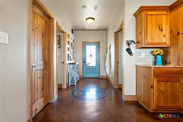 entryway featuring a textured ceiling