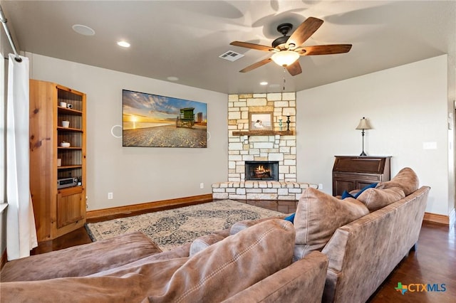 living room featuring a fireplace, dark hardwood / wood-style floors, and ceiling fan