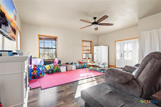 rec room featuring ceiling fan, cooling unit, and dark wood-type flooring