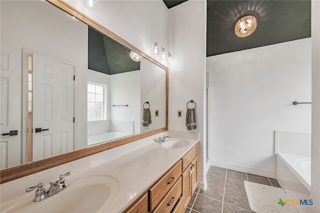 1921 Merlin Dr, Harker Heights, TX 76548 - bathroom featuring a garden tub, double vanity, tile patterned flooring, and baseboards