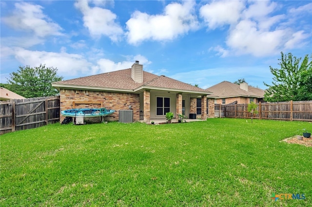 1921 Merlin Dr, Harker Heights, TX 76548 - back of house featuring central AC unit, brick siding, a chimney, and a shingled roof