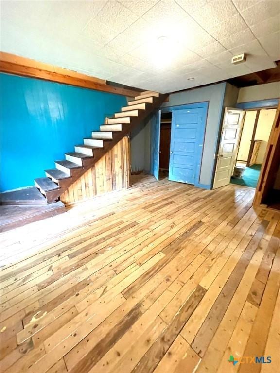 206 E Rogers St, Ganado, TX 77962 - finished basement with hardwood / wood-style flooring and stairway