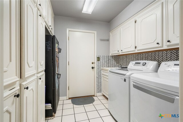 laundry room with cabinets, separate washer and dryer, and light tile patterned floors