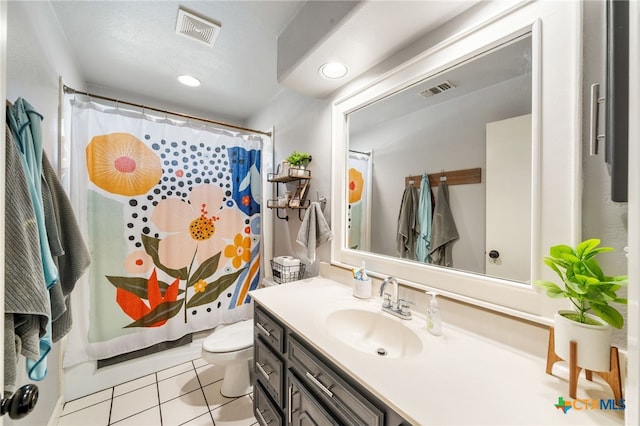 bathroom with tile patterned floors, toilet, curtained shower, and vanity