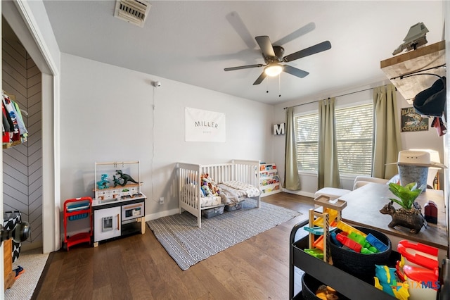 bedroom with ceiling fan and dark hardwood / wood-style floors