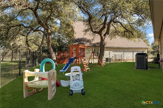 view of playground with central AC unit and a yard