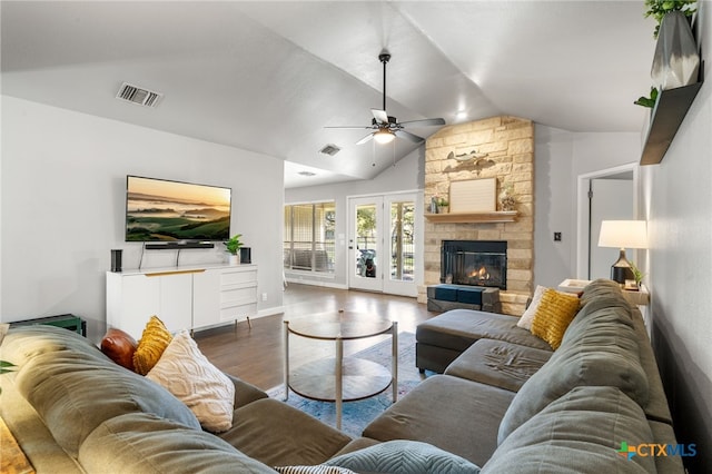 living room featuring ceiling fan, a fireplace, dark hardwood / wood-style floors, and vaulted ceiling