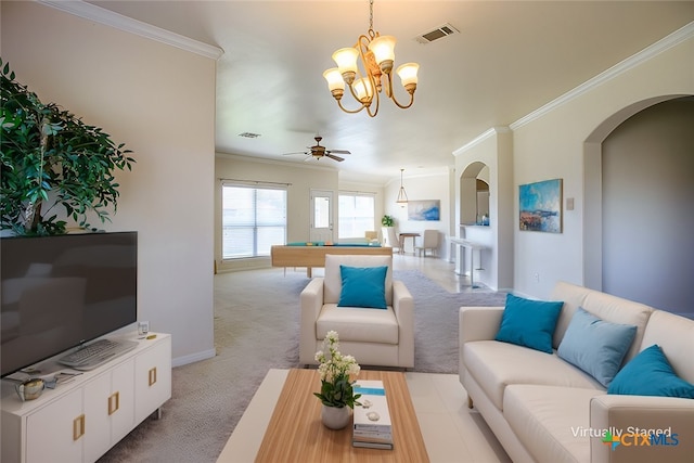 carpeted living room with arched walkways, visible vents, ceiling fan with notable chandelier, and ornamental molding