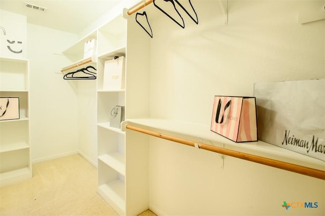 walk in closet featuring visible vents and carpet