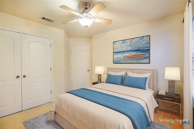 bedroom featuring a closet, visible vents, and ceiling fan