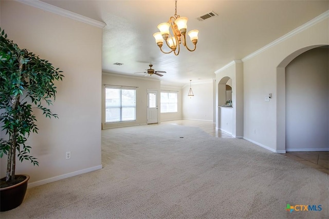 carpeted empty room with baseboards, visible vents, arched walkways, ornamental molding, and ceiling fan with notable chandelier