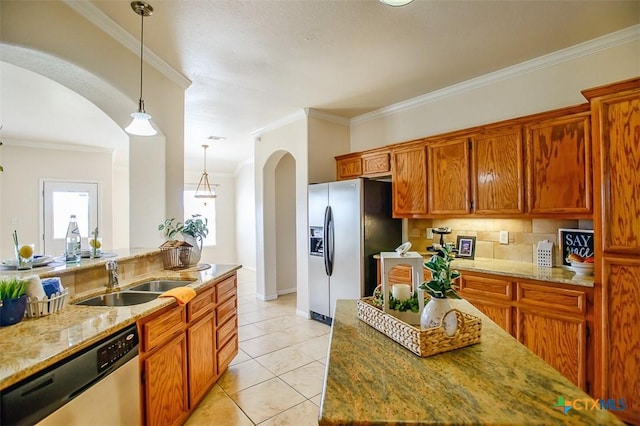 kitchen with light tile patterned flooring, arched walkways, a sink, ornamental molding, and stainless steel appliances