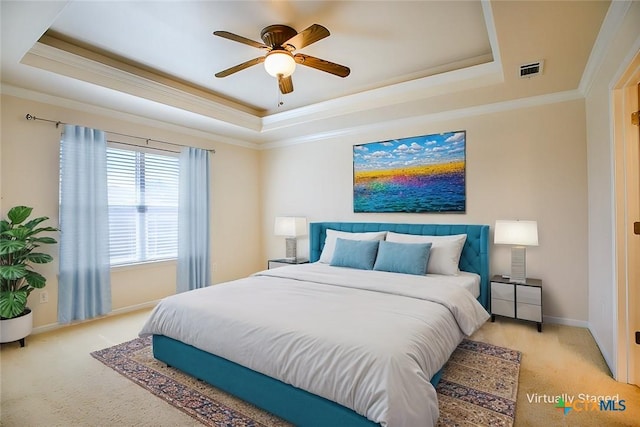 bedroom featuring a tray ceiling, crown molding, and visible vents