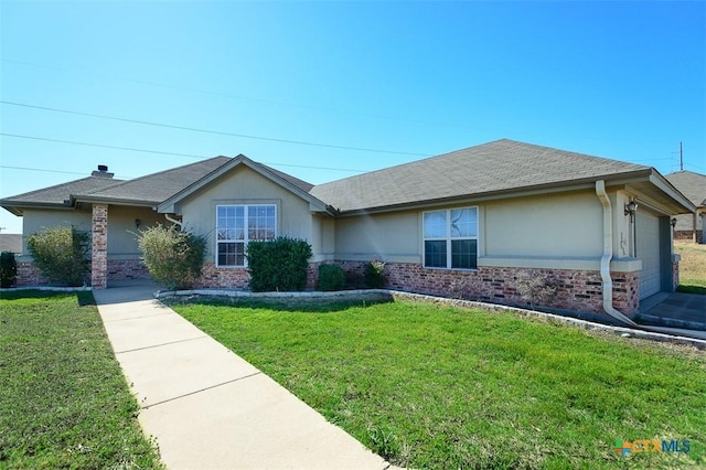 single story home with brick siding, stucco siding, an attached garage, and a front lawn