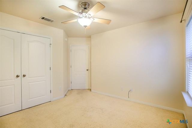 unfurnished bedroom with a ceiling fan, baseboards, visible vents, and a closet