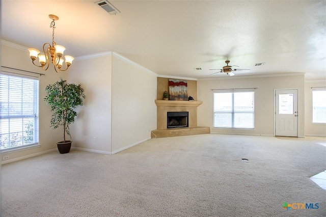 unfurnished living room with light colored carpet, a fireplace with raised hearth, visible vents, and ornamental molding