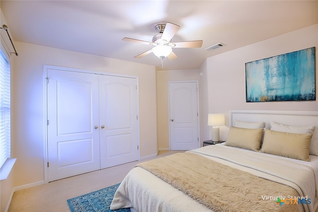 bedroom with visible vents, ceiling fan, baseboards, carpet floors, and a closet