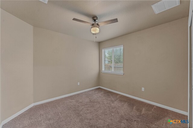 empty room featuring ceiling fan, carpet floors, and a textured ceiling