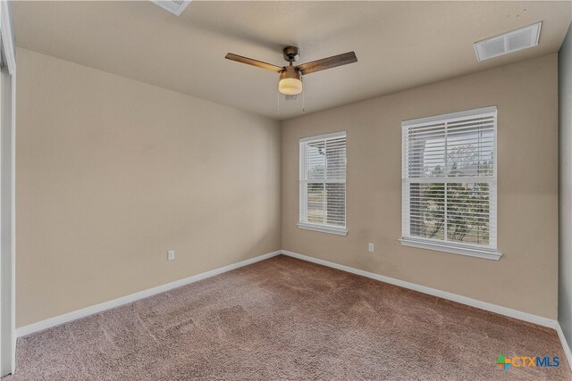 spare room with ceiling fan and carpet flooring