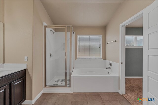 bathroom with tile patterned flooring, vanity, and independent shower and bath