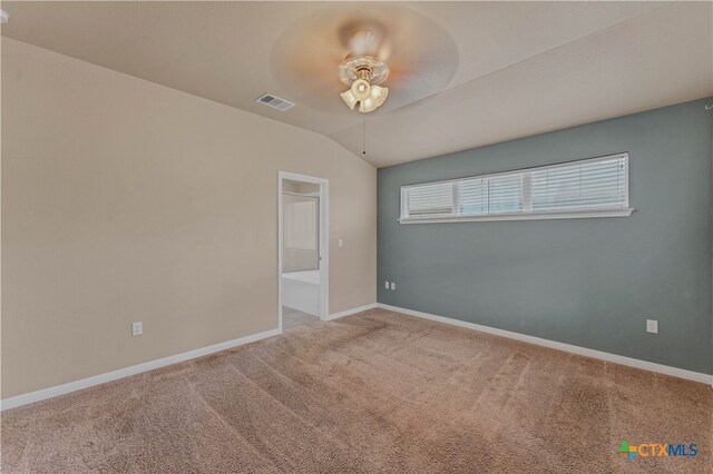 carpeted empty room with ceiling fan and vaulted ceiling