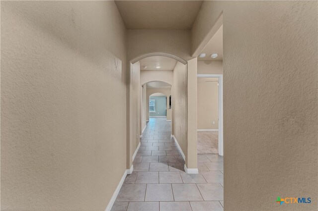 hallway featuring light tile patterned flooring