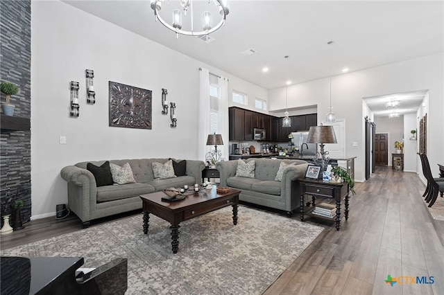 804 Blue Oak Blvd, San Marcos, TX 78666 - living area featuring light wood finished floors, a chandelier, and baseboards