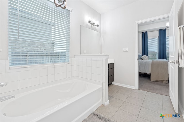 804 Blue Oak Blvd, San Marcos, TX 78666 - ensuite bathroom featuring tile patterned flooring, a garden tub, vanity, and baseboards