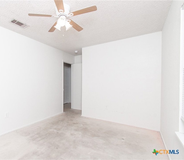 empty room featuring a textured ceiling and ceiling fan