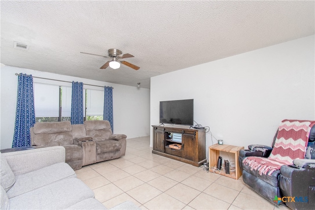 tiled living room featuring a textured ceiling and ceiling fan