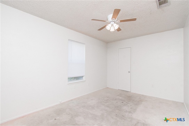 unfurnished room with ceiling fan, a textured ceiling, and light carpet