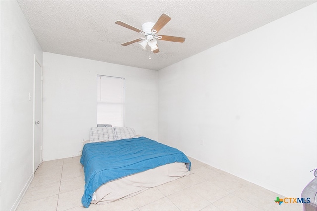 bedroom featuring a textured ceiling and ceiling fan