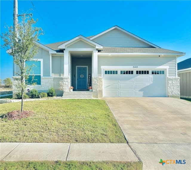 view of front of property featuring a garage and a front yard