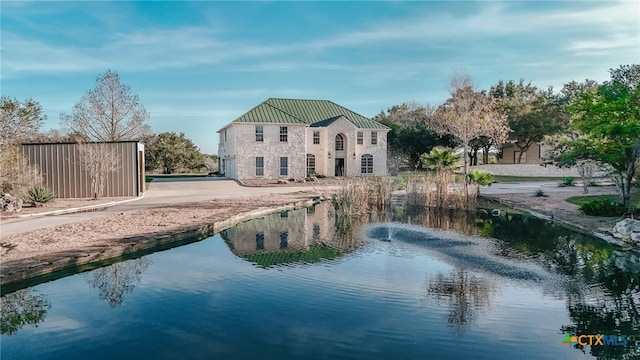 back of house featuring a water view