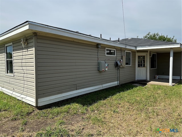 back of house with a lawn