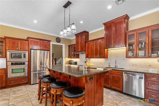 kitchen with visible vents, appliances with stainless steel finishes, ornamental molding, and a sink
