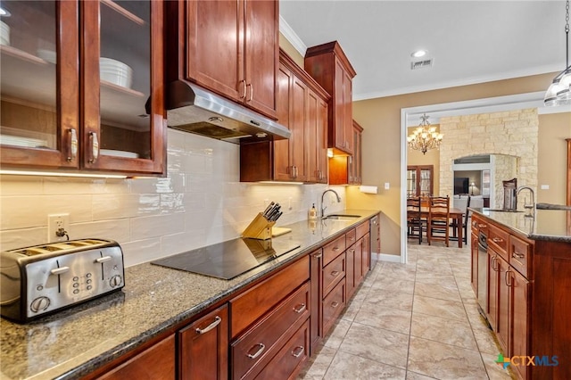 kitchen with under cabinet range hood, dark stone countertops, visible vents, a sink, and black electric stovetop