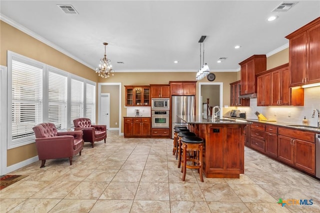 kitchen with crown molding, a sink, a chandelier, appliances with stainless steel finishes, and visible vents