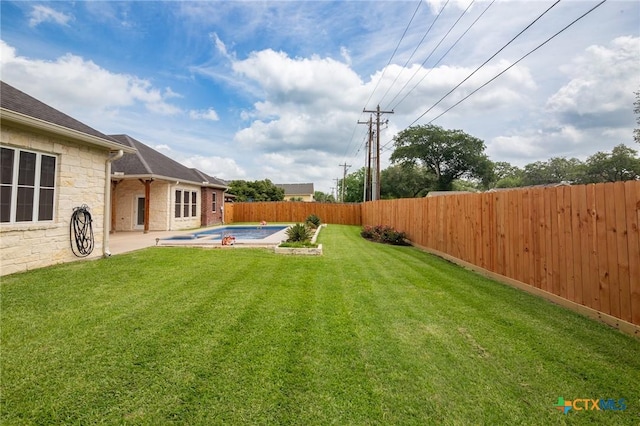view of yard with a fenced backyard, a patio area, and a fenced in pool
