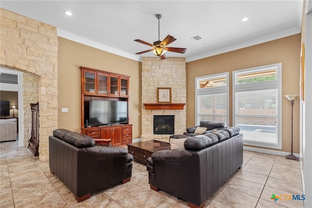living room with visible vents, ceiling fan, crown molding, a fireplace, and light tile patterned floors