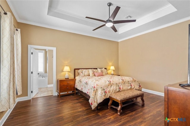 bedroom featuring visible vents, a tray ceiling, dark wood-style floors, and ornamental molding
