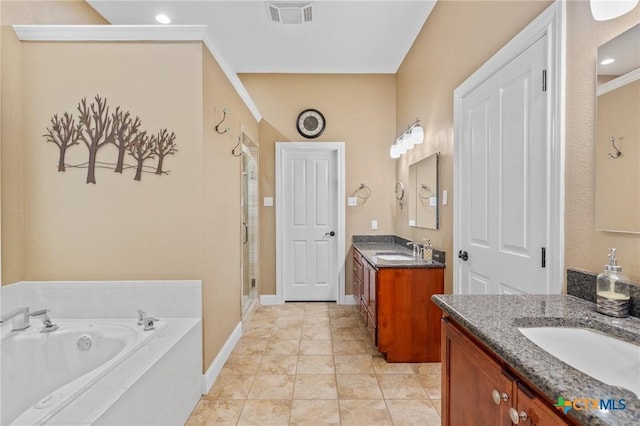 full bath with two vanities, visible vents, a sink, and a stall shower